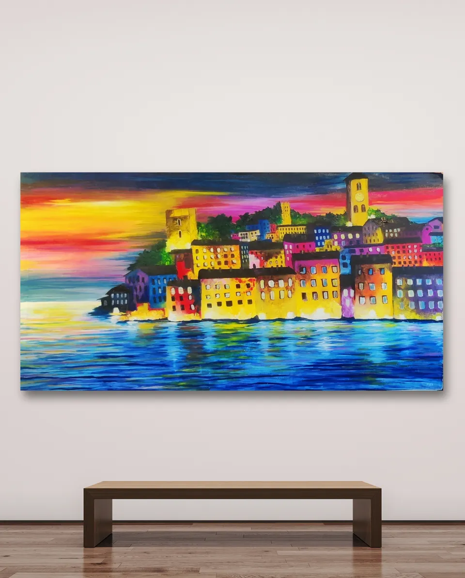 Framed painting of a colourful hillside town reflected in a lake