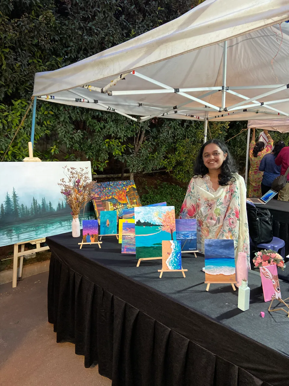 Sobha Art Booth 2023: artist arranging booth display 1