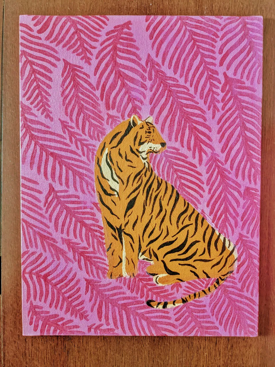 Illustration of a tiger surrounded by a vivid pink botanical pattern